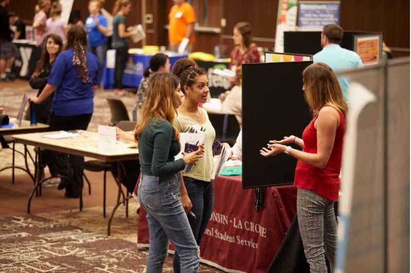Students visit a booth at a job fair on the UW-La Crosse campus.
