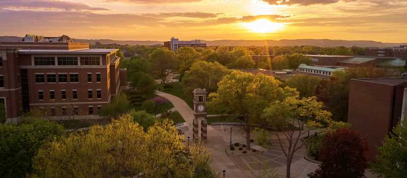 view of UWL campus with a setting sun