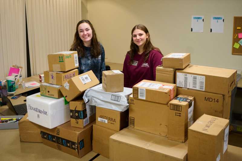 UWL's Eagle Mail Center is one of the busiest places on campus — receiving, processing and distributing mail for all campus residence halls. Pictured are Mail Center assistant Katie Noe (left) and graduate assistant for Residence Life operations Jordan Vlasak. 