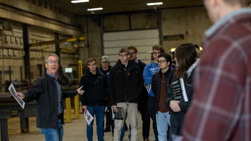 Paul Bagniefski, far left, president of Mid-City Steel, leads UW-La Crosse accountancy students on a tour of the company's manufacturing facilities. This spring, students are gaining real-world accounting experience through a partnership with Mid-City Steel — part of UWL's Community Engaged Learning program.