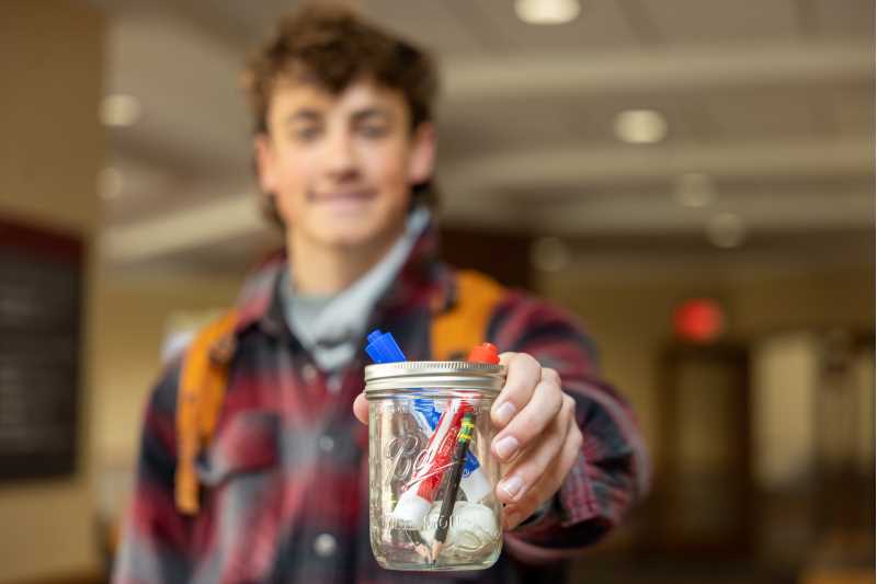 “At the core root it is about human’s being vulnerable,” says student Isaac Olson. Here Olson shares his jar containing a brain created out of sculpted clay, some pencils and expo markers that represent his future dream of teaching high school social studies.