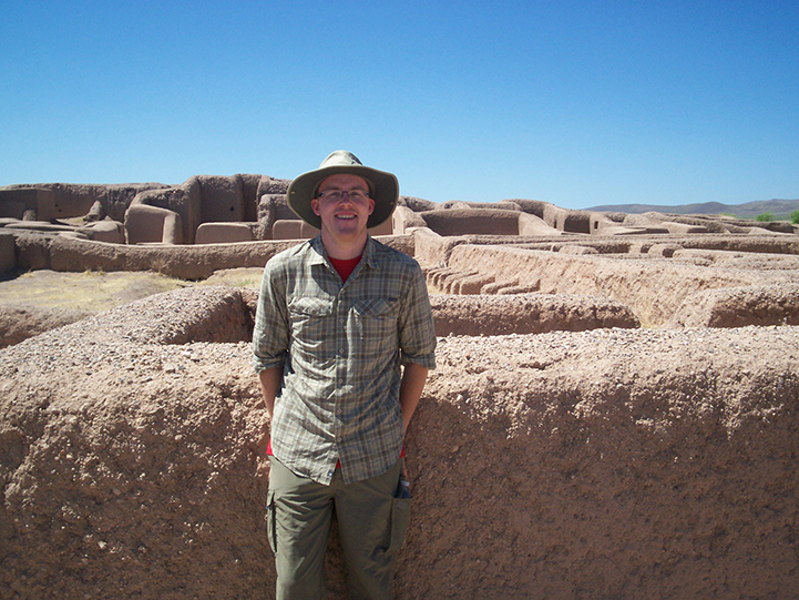 UW-L Senior Thatcher Rogers poses in front of prehistoric architectural remains in the desert. 