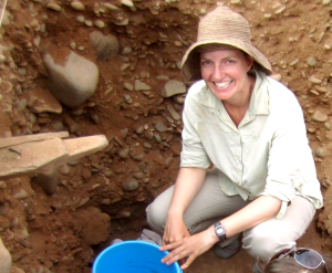 Image of Katherine Grillo sitting at an excavation site. 
