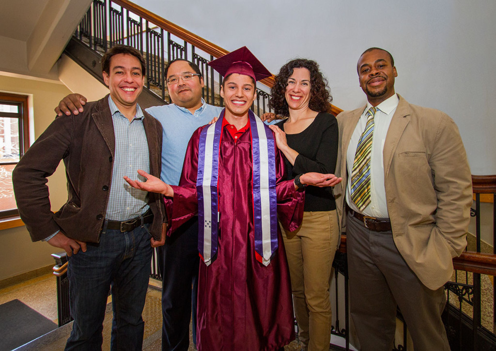 Image of José Rubio-Zepeda in his graduation gown and hat, surrounded by the four UW-L faculty members. 