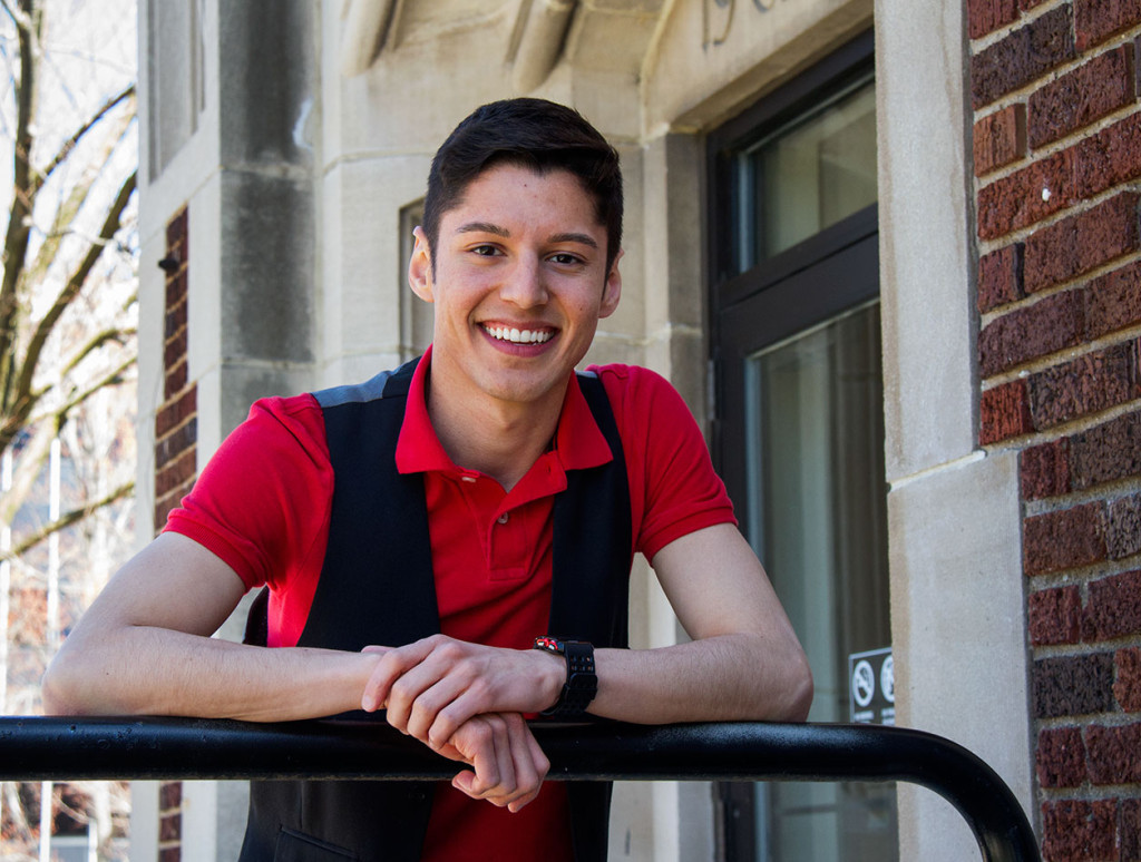 Image of UW-L student José Rubio-Zepeda leaning up against a railing on a UW-L building. 