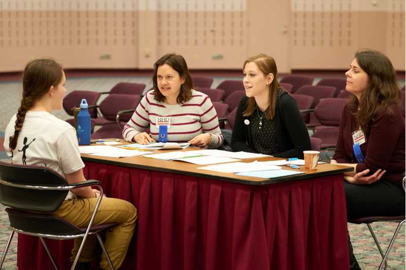 panel of judges talking to a student 2016 NHD