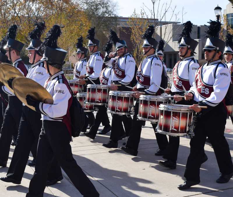 Drumline marching across campus before a football game