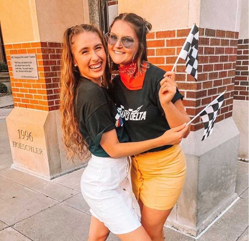 Alpha Xi Delta women pose in their Race-themed bid day outfits.