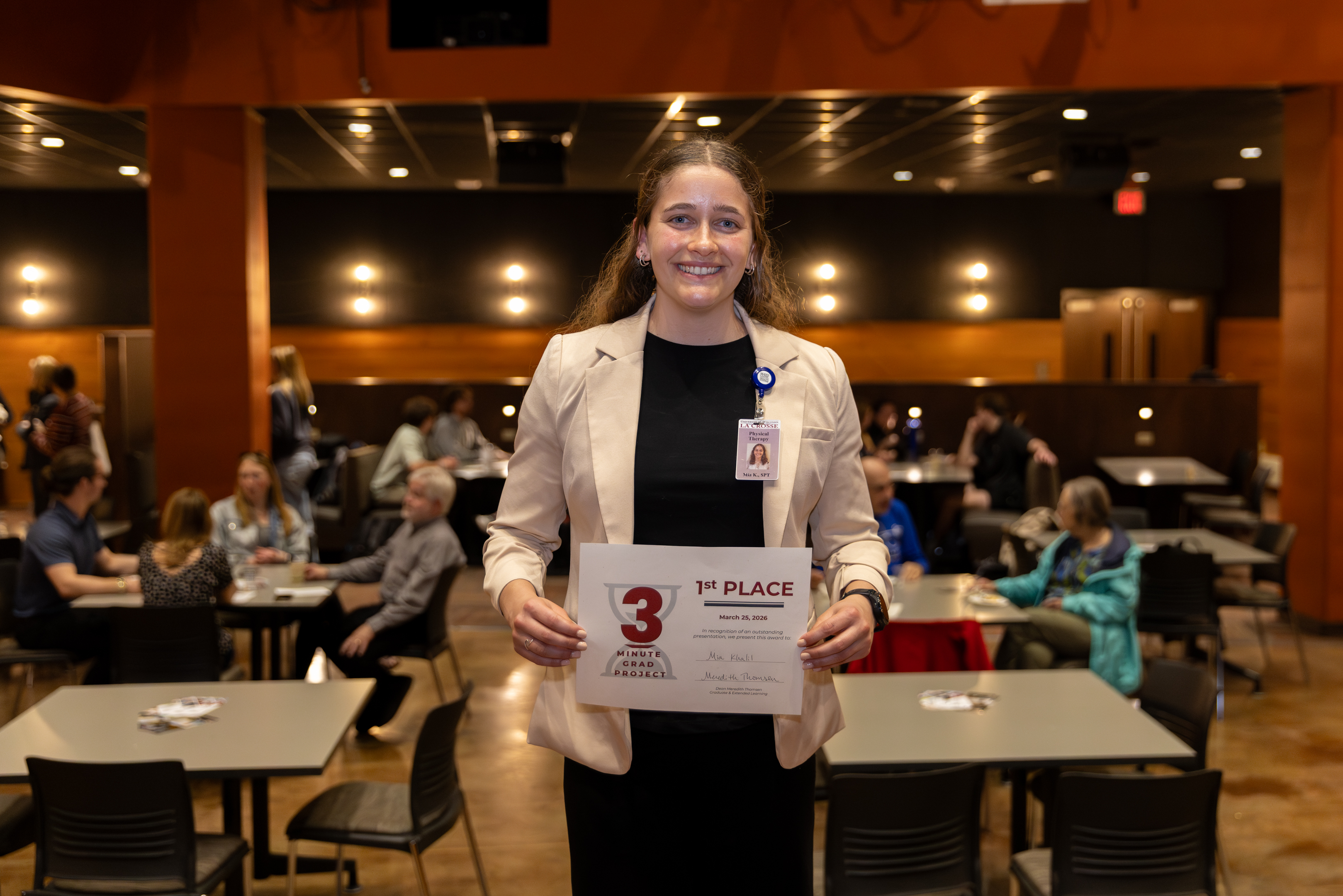 3 Minute Grad Project Competition first place winner with her certificate.