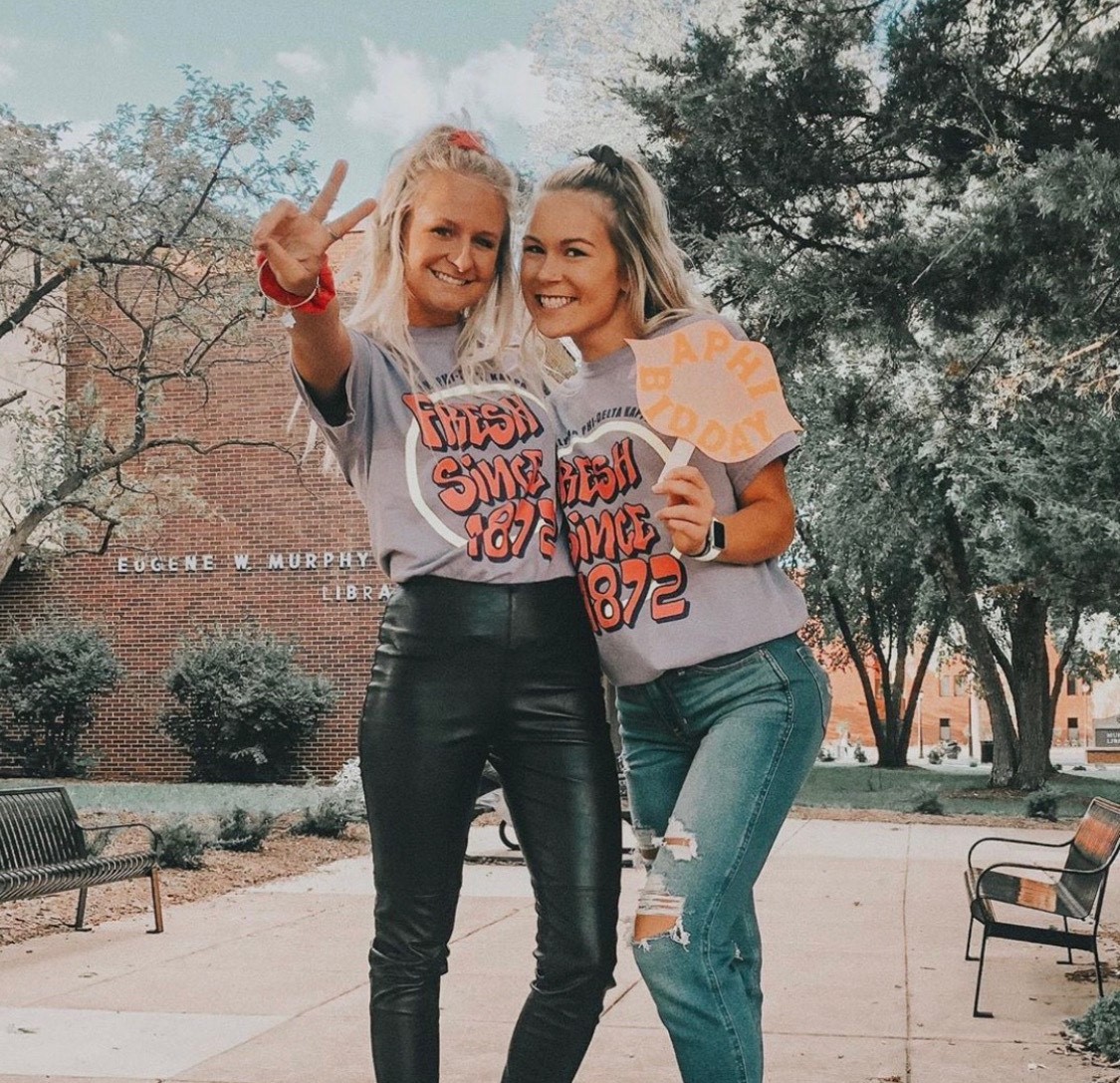 Two Alpha Phi members pose for a photograph during their Bid Day Celebration.