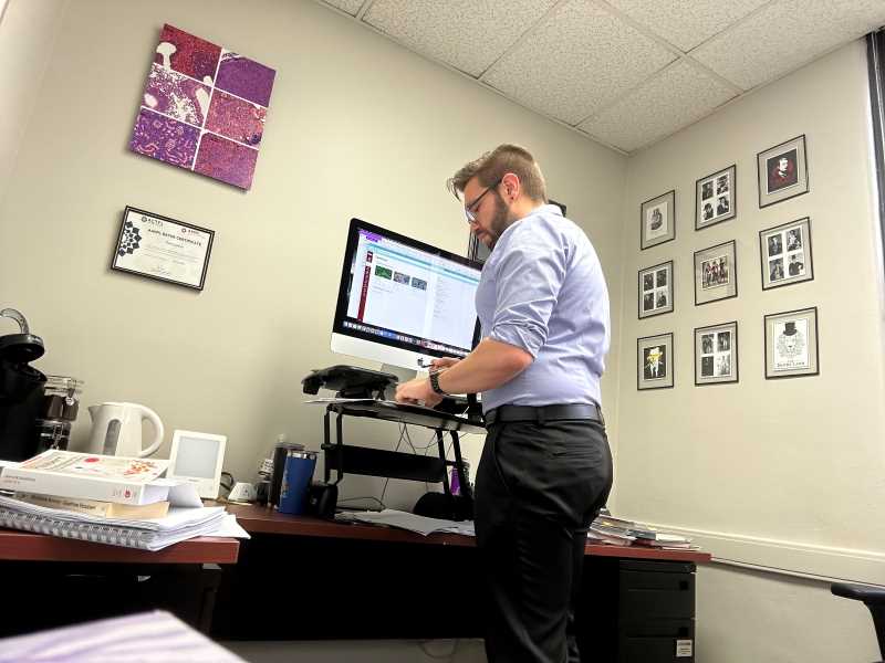 Dr. Jacob writing in his office.