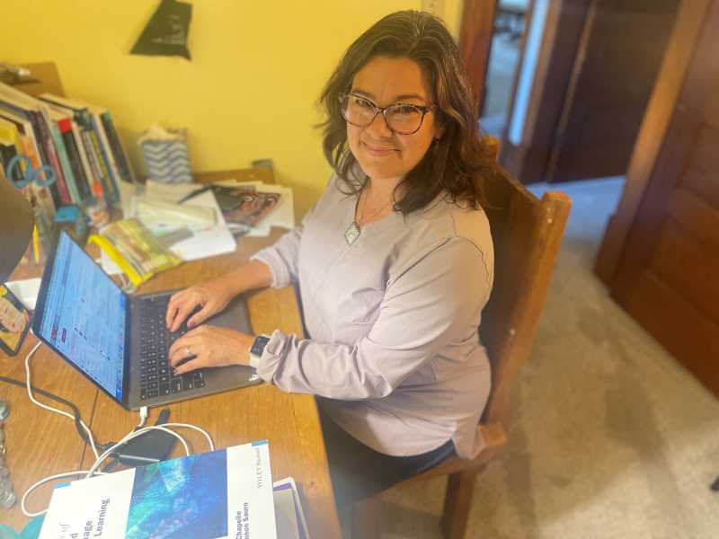 Dr. Heather Linville writing in her home office. 