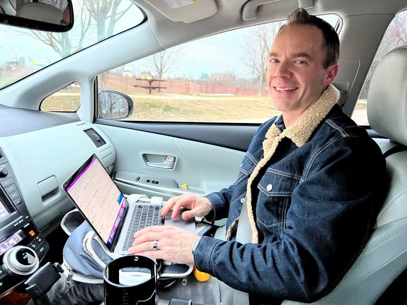 Dr. Ryan McKelley writing in his mobile office.