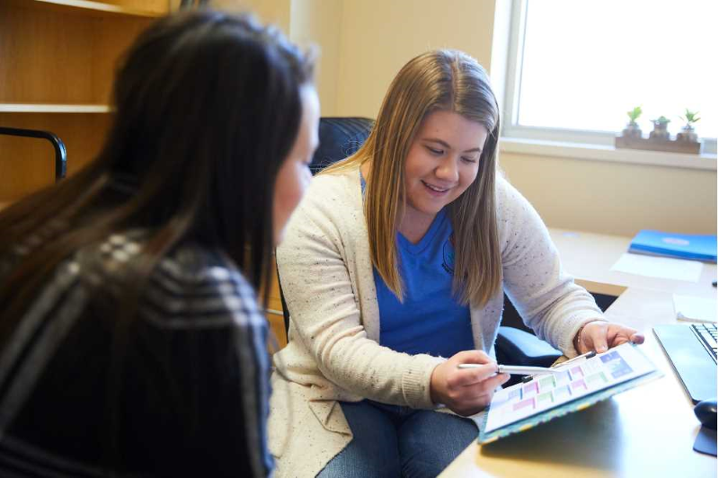 A peer mentor works with a UW-La Crosse student as part of the It Make$ Cents financial literacy program that aims to addresses financial concerns of students that are unique to college life. Photo taken in early 2020.