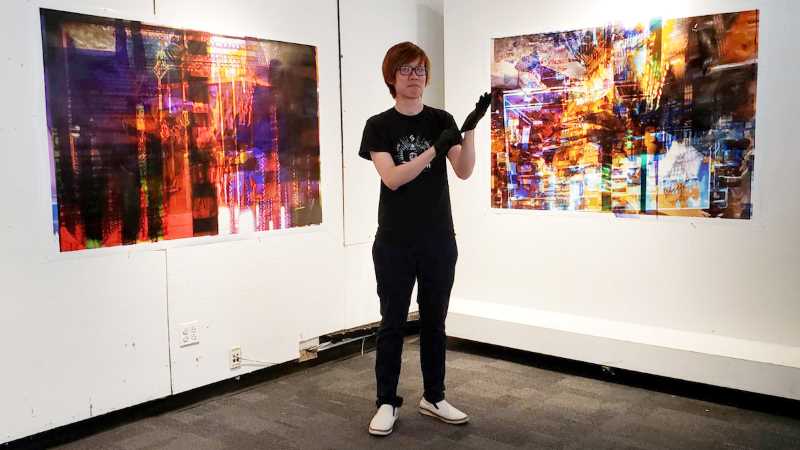 UWL Alumnus Harold Lee in front of one of his pieces of art.