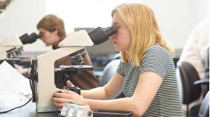 Students looking through microscopes