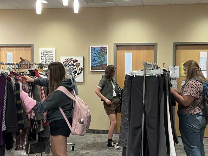 Students look through the Campus Thread, a free clothing closet available to all students.