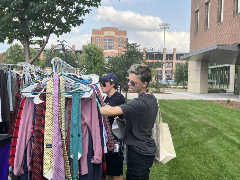 Students looking through the Campus Thread rack