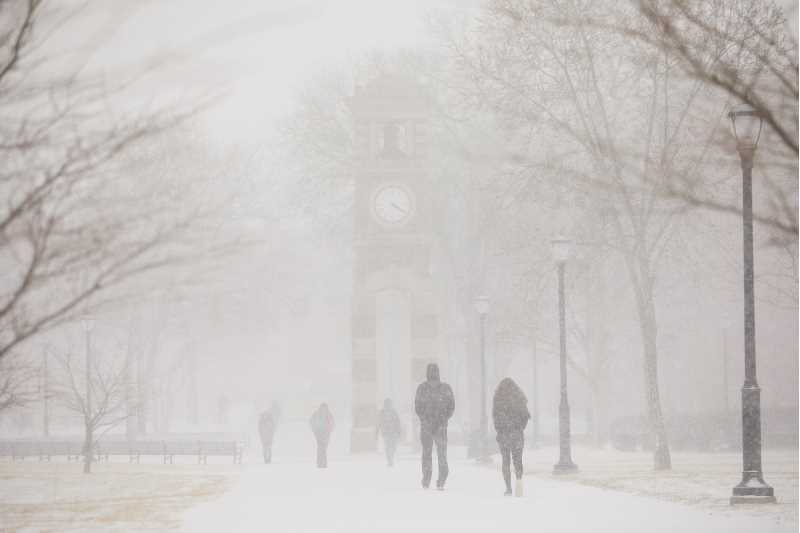 Students walking through snow on campus