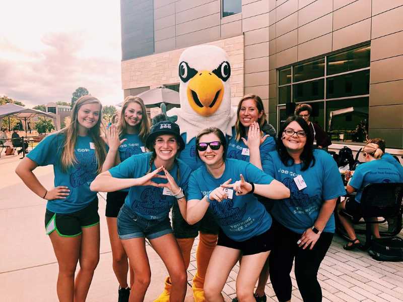 Sorority Women posing with Stryker Eagle. 