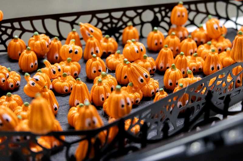 Alt text: a detailed image of Kelly Peter's pumpkin submission with mini pumpkins made to look like a concert crowd.