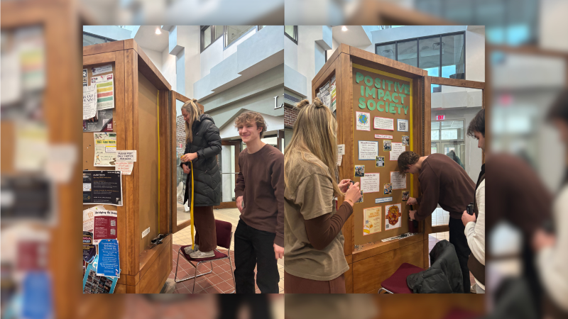 Alt Text: Students set up their display in the Student Org Display Area in the Murphy Library atrium.