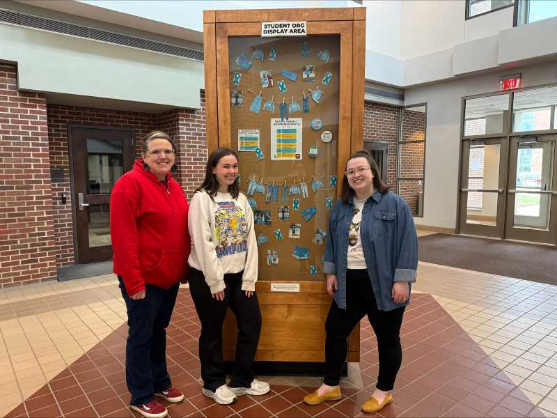 Blythe Mcconaughey, Maddie Stephani, and Issy Beach using the SODA (Student Org Display Area) to create awareness for Sexual Assault Awareness Month.
