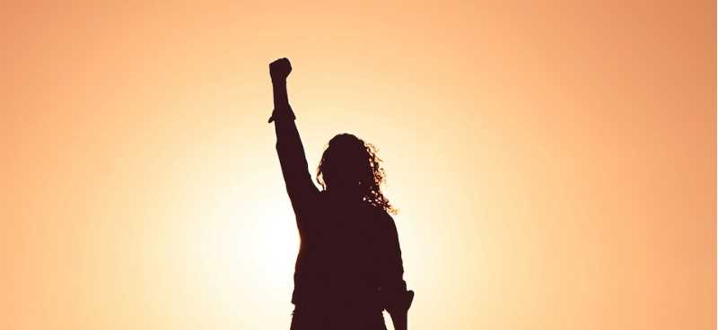 Silhouette of person raising one arm in the air, Photo by Miguel Bruna on Unsplash