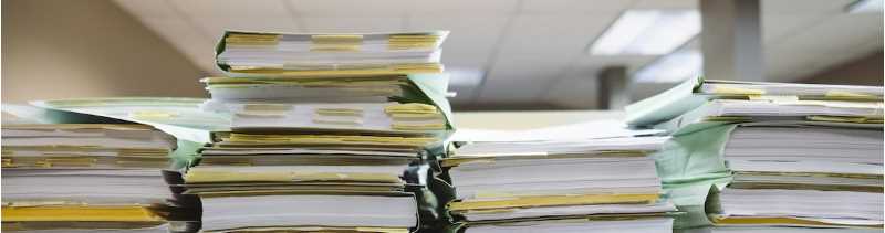Stack of files, Photo by Wesley Tingey on Unsplash