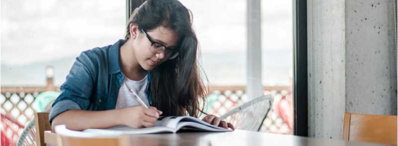 Woman reading a book, photo credit to Kyle Gregory Devaras on Unsplash