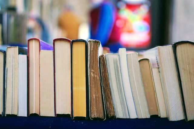 decorative image of books stacked horizontally