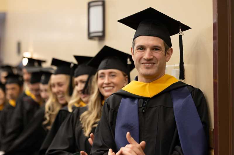 Spring 2025 Graduate Studies Hooding Ceremony at UW-La Crosse. Learn how you can afford a graduate school with the help of tuition reimbursement.