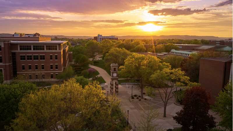 A sun sets over Hoeschler Tower.