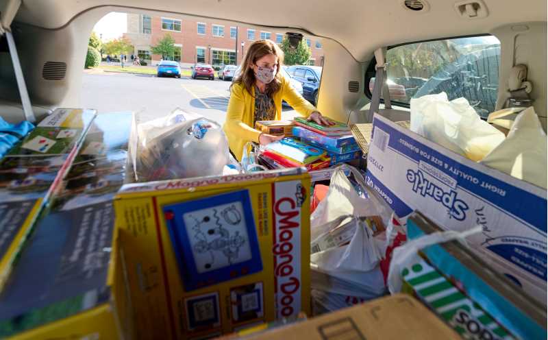 Lisa Klein, UWL Community Engagement Coordinator, loads toys collected for Afghan children at Fort McCoy. The two-week, campus-wide effort netted around 400 toys. 