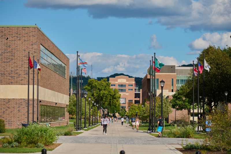 International flags fly along the Badger Street mall on the UWL campus. Two UWL educators are among those discussing ways to support Afghan evacuees at Ft. McCoy during an upcoming panel discussion.