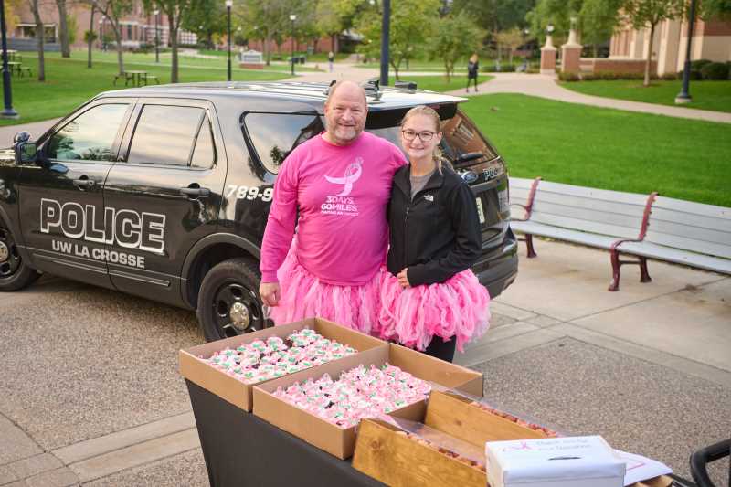 UWL Police Officer Dave Pehl and his daughter, Madelynne, set up shop under UWL's Hoeschler Tower Thursday morning to raise money and awareness in the fight against breast cancer.