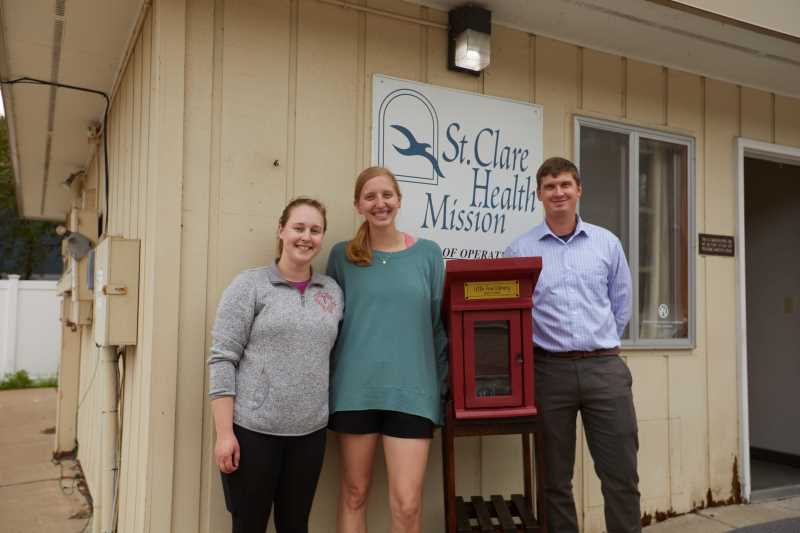 Austin Bol, right, with fellow UWL Physician Assistant Student Society members Elise Kreger, left, president, and Allison Riemersma, vice president, with the Little Free Library they presented to the St. Clare Health Mission. Bol has a special connection to the worldwide network of neighborhood libraries — his dad, Todd Bol, founded the organization.