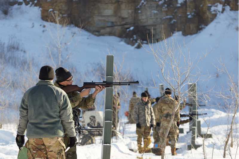 A cadet fires an air rifle during the weapons lane challenge.