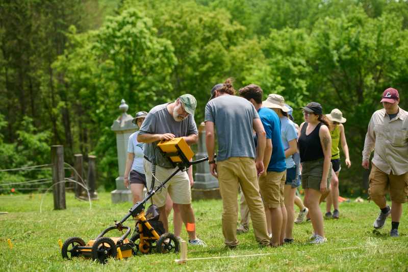 UW-La Crosse Professor of Archaeology David Anderson shows his students how to use ground-penetrating radar at the Crooked Creek Germany Pioneer Cemetery in rural Houston County, Minnesota. Anderson and his students are searching the area for unmarked graves — an important step in the cemetery's restoration.
