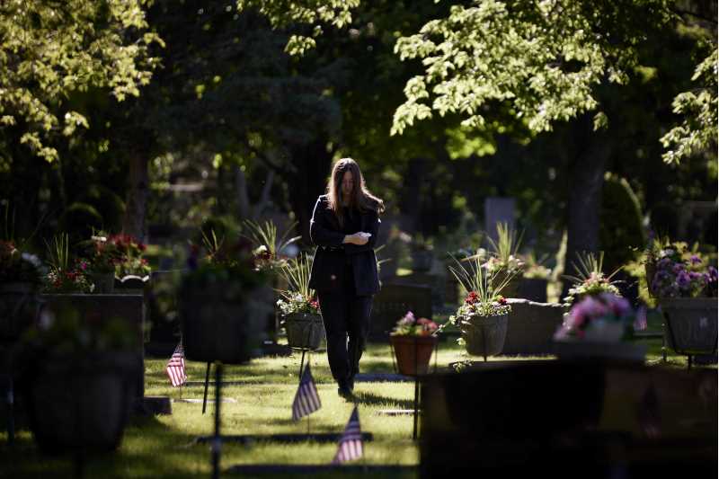 Image of someone walking in a cemetery. Communicating support is about personalities and not generalities, explains Dena Huisman, UWL associate professor of Communication Studies.