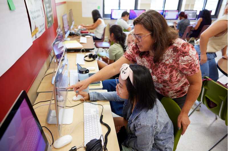 UW-La Crosse Professor of Educational Studies Heather Linville helps local middle school student Julia Bacalso on her digital storytelling project. Through the 