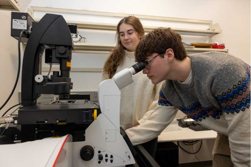 UWL biology major Ross Hobson and biology graduate student Kori Kruegel examine a sample using the Biology Department's new confocal microscope. This new device has allowed students and faculty to tackle microcopy projects that were impossible, or extremely difficult, with older equipment.