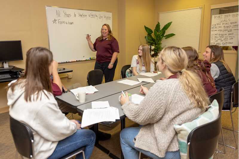 Jennifer Taylor leads a meeting of students and faculty at the research center in the Health Science Center.