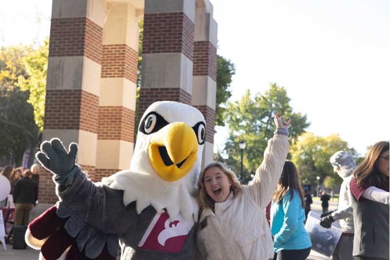 Kendall Bowman, strategic event coordinator with the UWL Alumni & Friends Foundation, celebrates with Stryker Eagle during One Day for UWL in 2024.