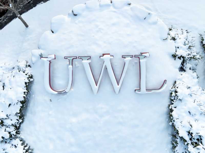 The UWL letters, blanketed in snow, on the UW–La Crosse campus.