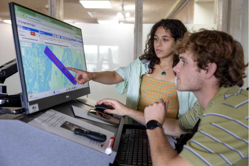 UWL Dean’s Distinguished Fellows working with Professor Niti Mishra have been using Google Earth Engine extensively this summer to process and analyze large drone and satellite datasets. Both DDF students were funded during summer 2026 through donor gifts: Finn Patenaude, right, from the Prairie Springs Endowment and Anna Neuenfeldt from Dan Gelatt. 