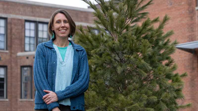 Prairie Springs Environmental Leadership Awardee (instructor) Alysa Remsburg is a teacher in the Sustainability and Environmental Studies program. She is pictured by a white pine on The Hįnųkwas Tree Trail on campus. The tree species Ho-Chunk name is Waazí́xjį. 