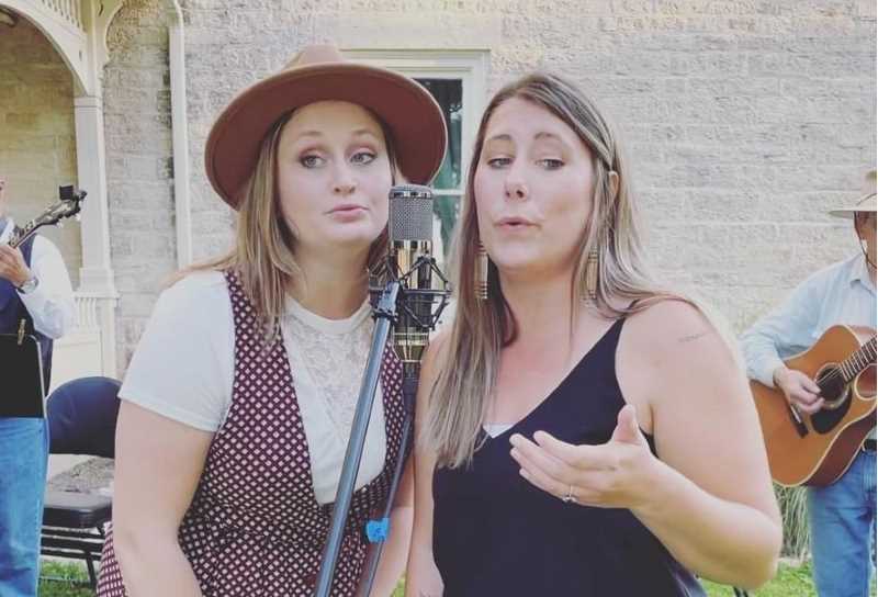 Cori Vought, ’15 (left), and Sarah Jackson, ’14, perform at the Under the Stars concert series at the Old Main Historical & Community Arts Center in Galesville. The pair are vocalists for the Band Coulee Creek, which pays tribute to folk music icons Hazel Dickens and Alice Gerrard.