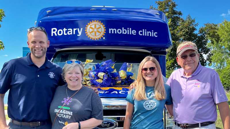 From left to right: Rotarians Josh Mansee, '10; Janie Morgan, ’85 & ’86; Marissa Dickinson; and Dean Dickinson, ’68; show off St. Clare Health Mission's new Rotary Mobile Clinic. UWL alumni were critical in securing funding for the project.