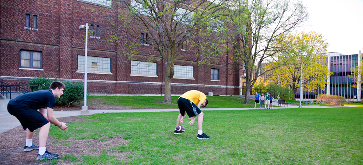 Students playing with football. 